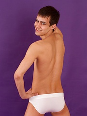 Pretty sporty straight guy is posing in white briefs and socks